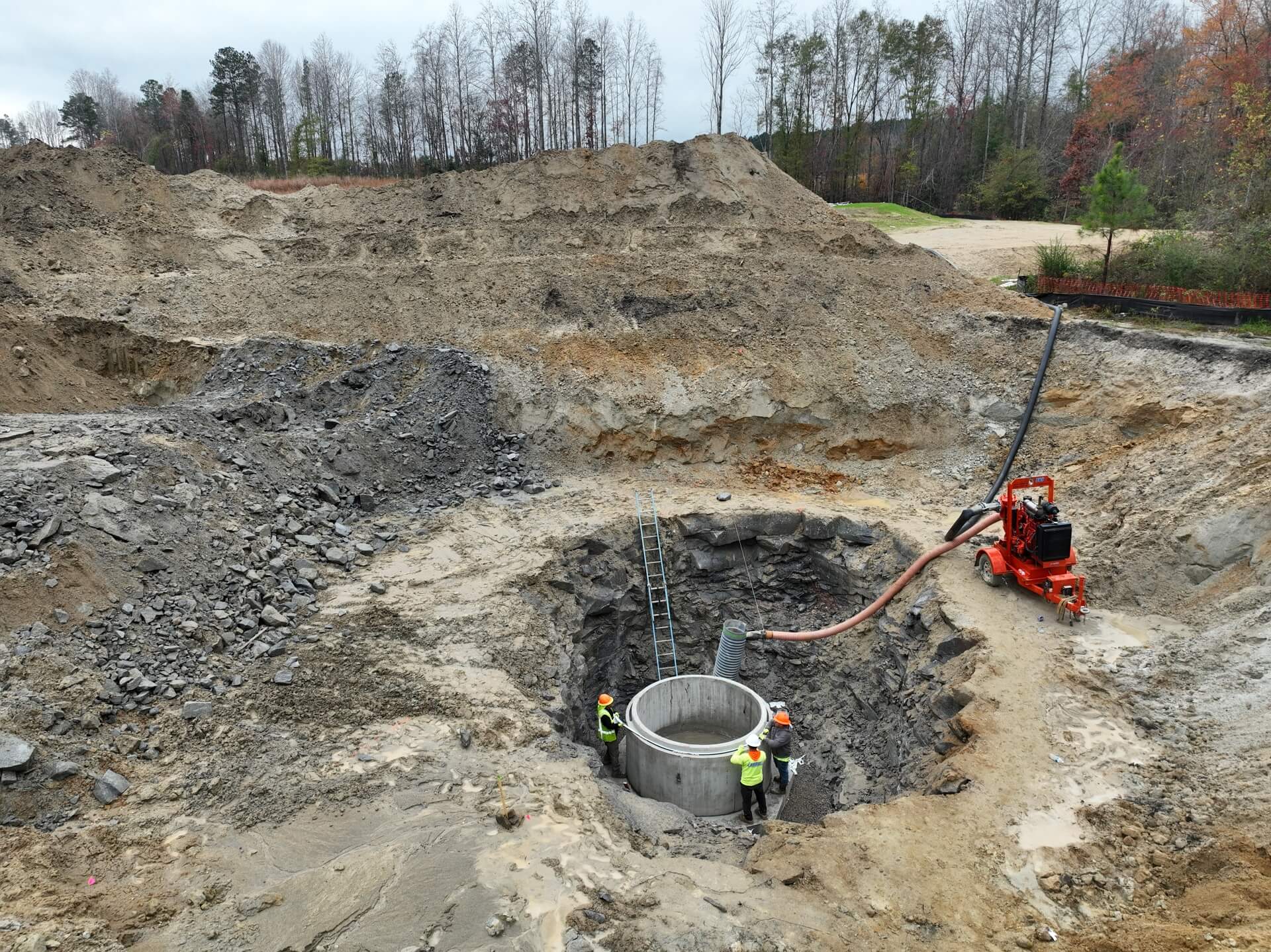 Manhole structure set in blasted rock on a Marks utility site