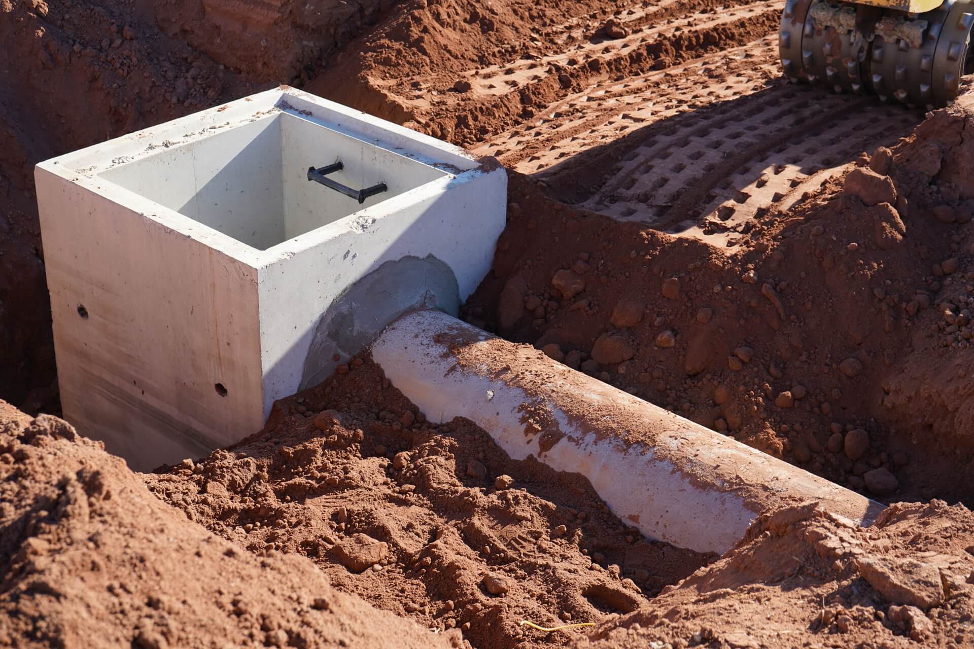 Precast storm drainage junction box set and connected on a Marks jobsite