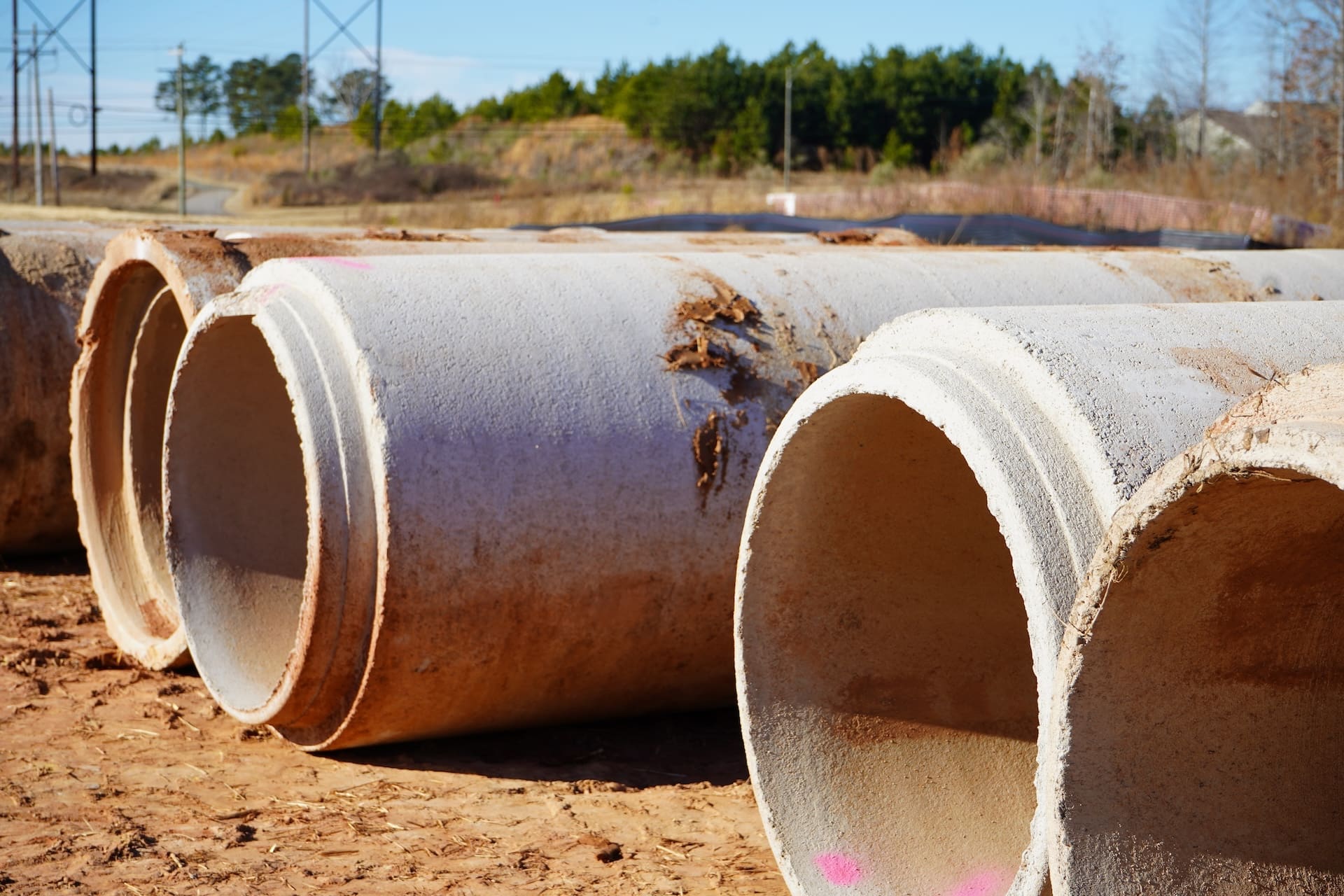 Reinforced concrete pipe staged on a Marks Clearing and Grading utility site